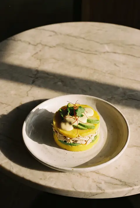 A portion of causa limena on a white plate