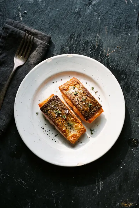 Salmon, about 100 g, on a white plate