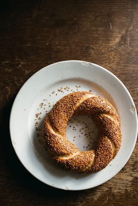 A simit on a white plate
