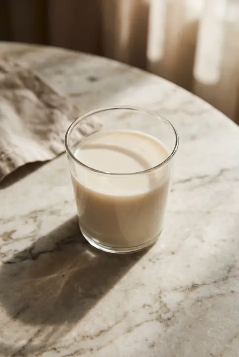 250 ml of unsweetened almond milk in a clear tumbler