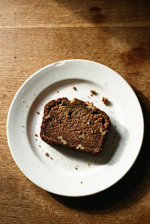 A slice of banana bread on a white plate
