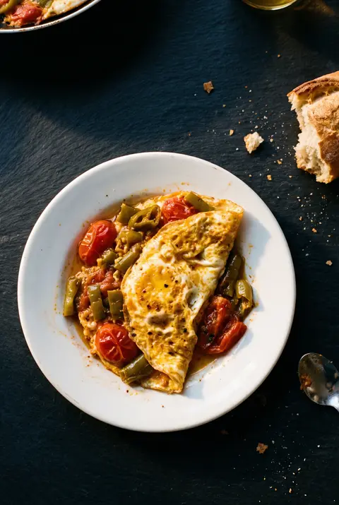 A small pan of menemen for one on a white plate