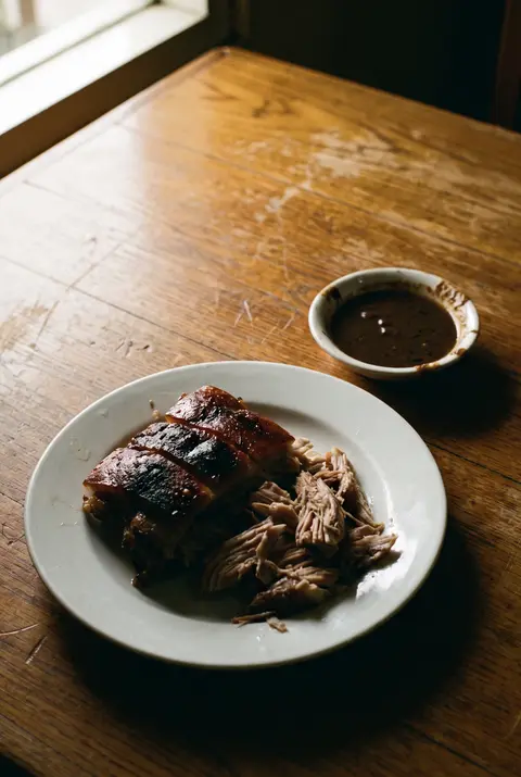 A portion of lechon on a white plate