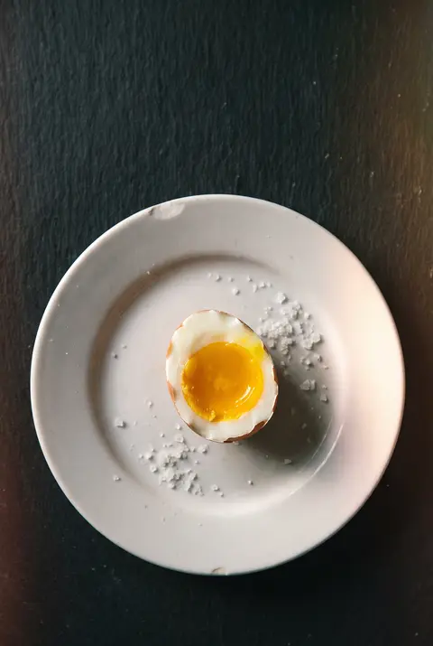 A boiled egg on a white plate