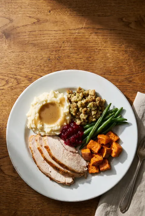 A full plate of roast turkey on a white plate