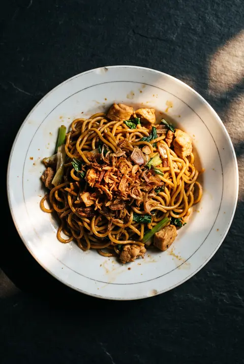 A plate of mie goreng on a white plate