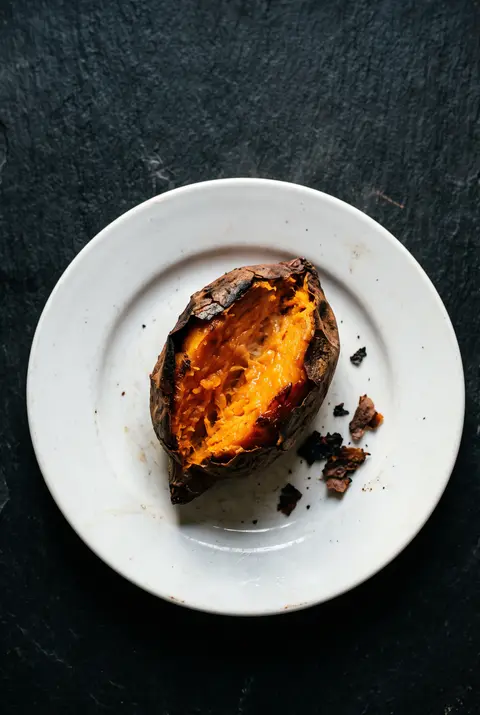 Sweet potato, about 100 g, on a white plate