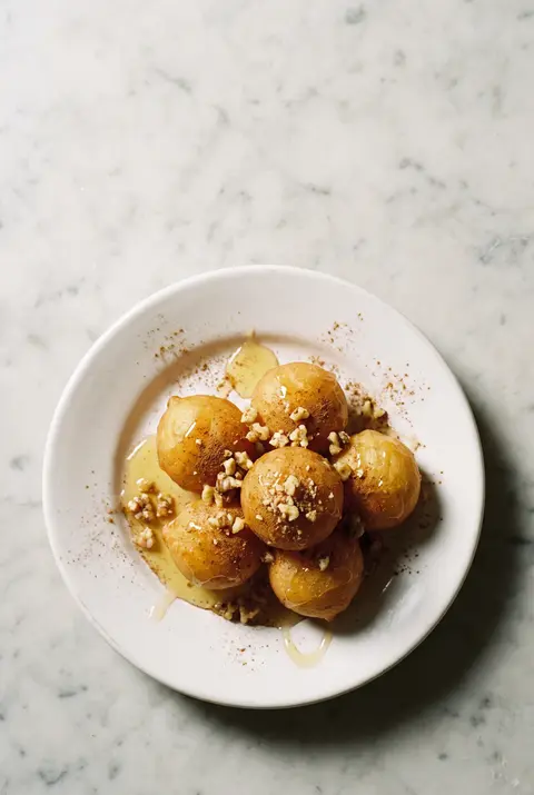 A portion of loukoumades on a white plate