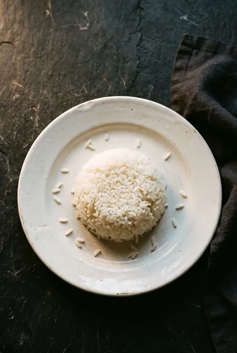 Rice, about 100 g, on a white plate