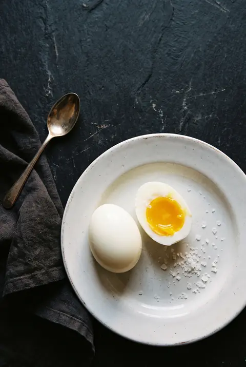 Egg, about 100 g, on a white plate