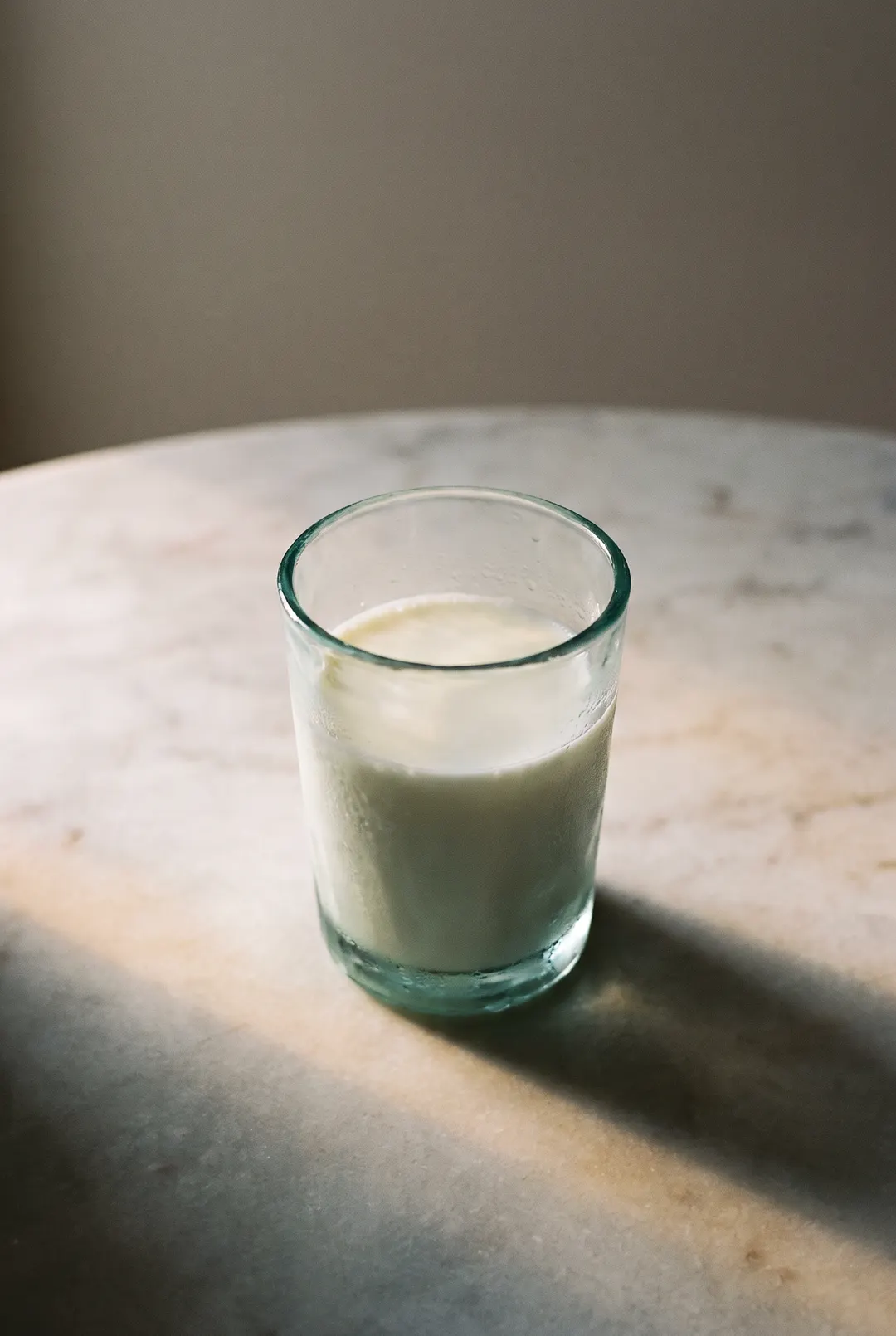A glass of cold milk in a clear glass