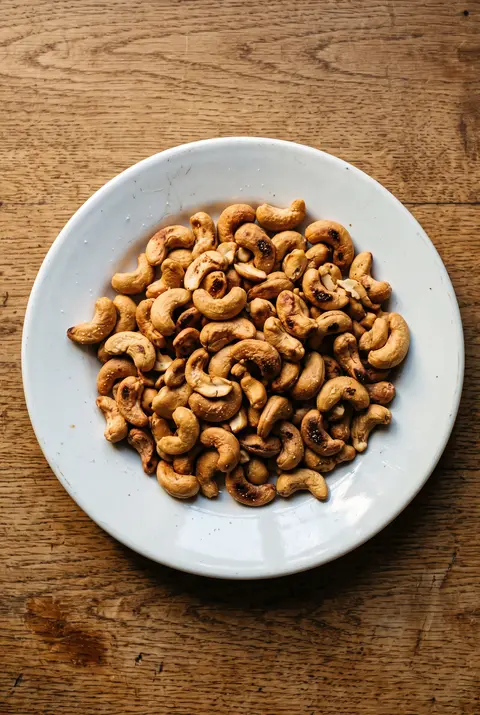 Cashews, about 100 g, on a white plate