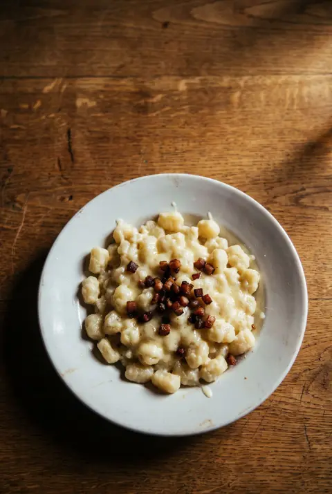 A full plate of bryndzove halusky on a white plate