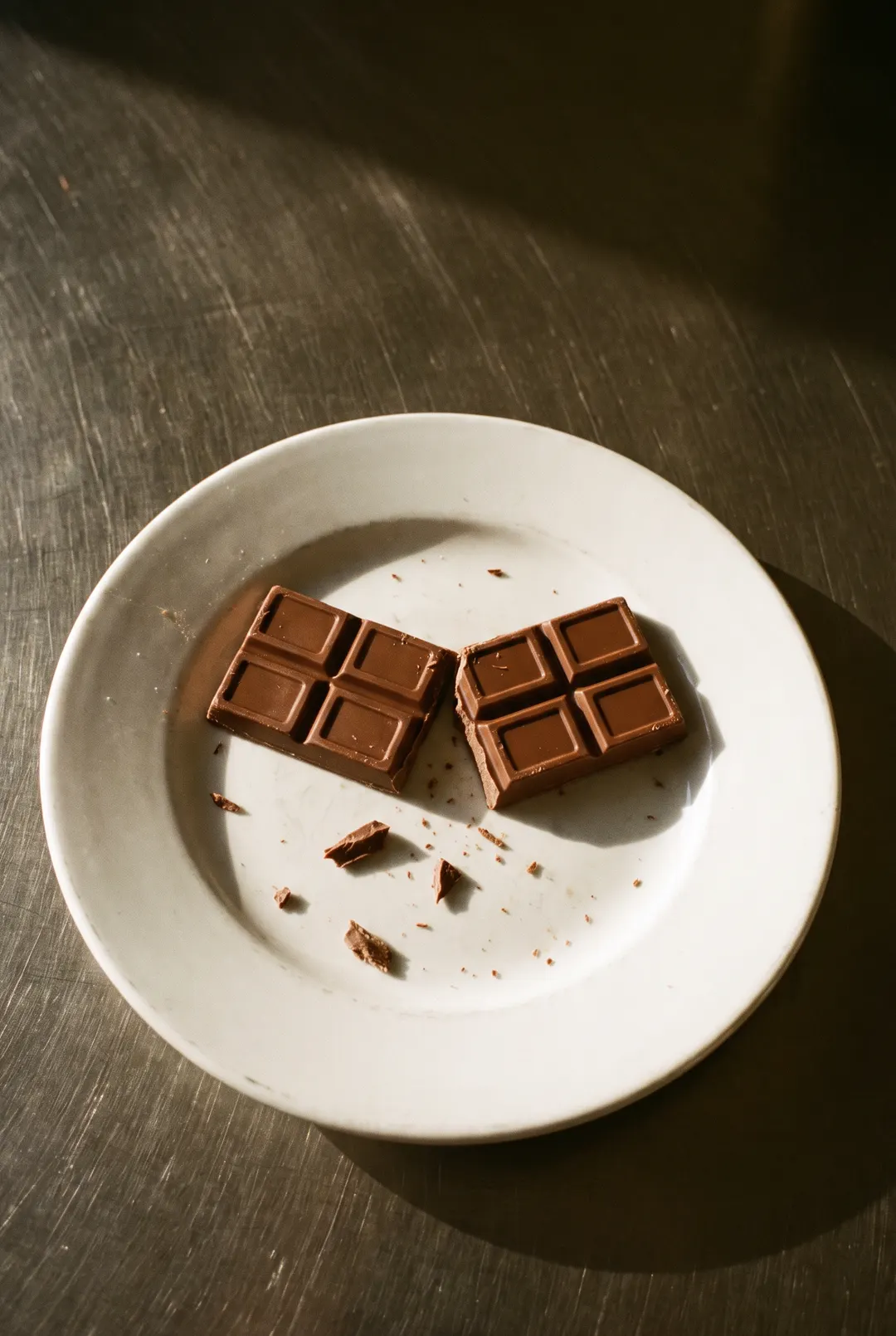 A milk chocolate bar on a white plate