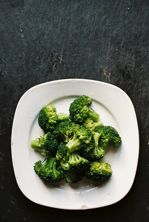 Broccoli, about 100 g, on a white plate