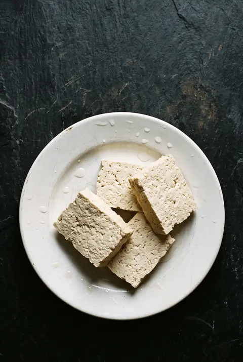 Tofu, about 100 g, on a white plate