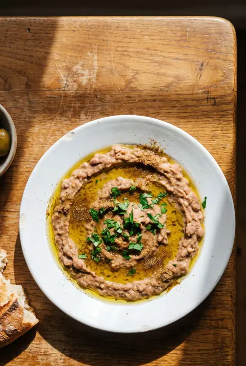 A plate of ful medames on a white plate