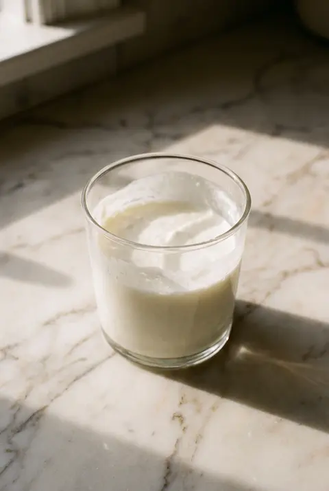 250 ml of thick white kefir in a clear tumbler