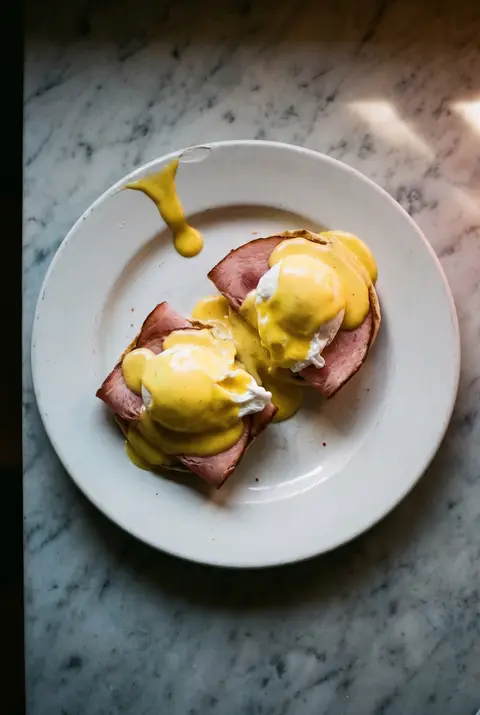 Eggs Benedict on a white plate